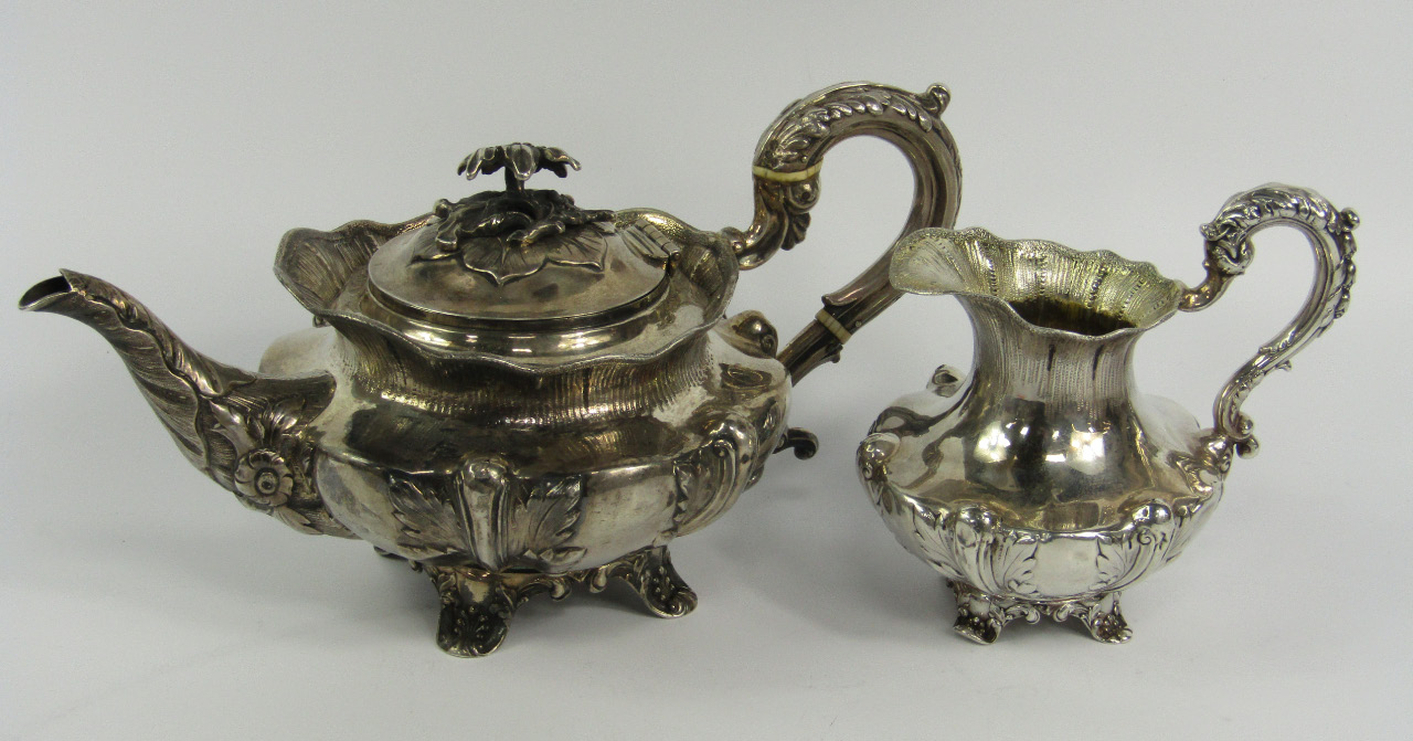 Appraisal: A William IV silver teapot and cream jug of compressed