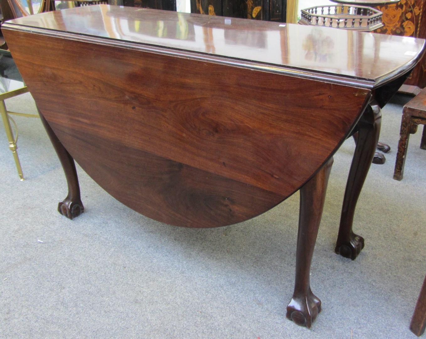 Appraisal: A mid th century plum pudding mahogany drop flap table