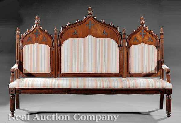 Appraisal: An American Gothic Carved Walnut Sofa c arched crocketed tripartite