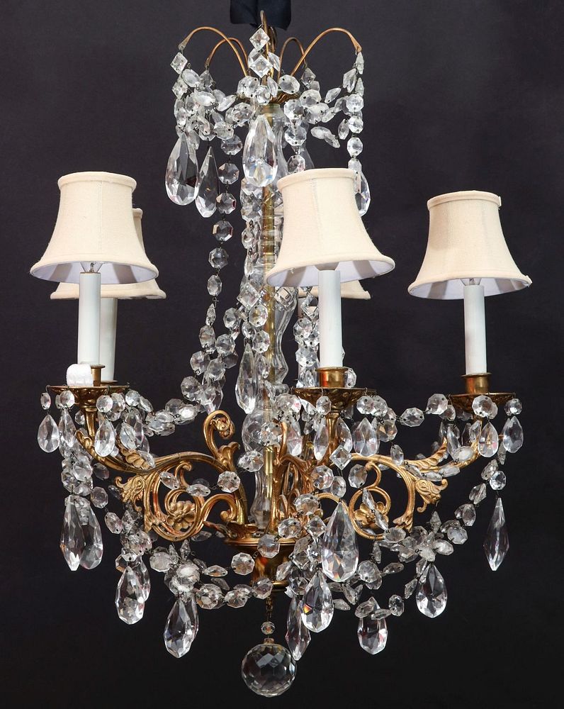 Appraisal: A GILT BRONZE AND CRYSTAL CHANDELIER The corona of acanthus