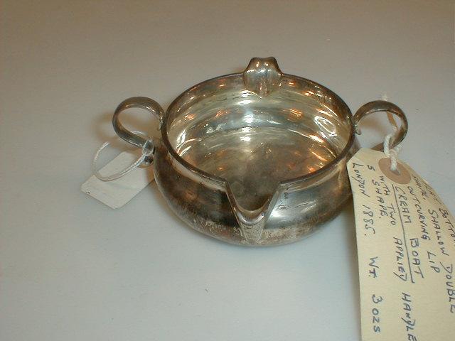 Appraisal: A Victorian silver double lip cream boat with applied S-scroll