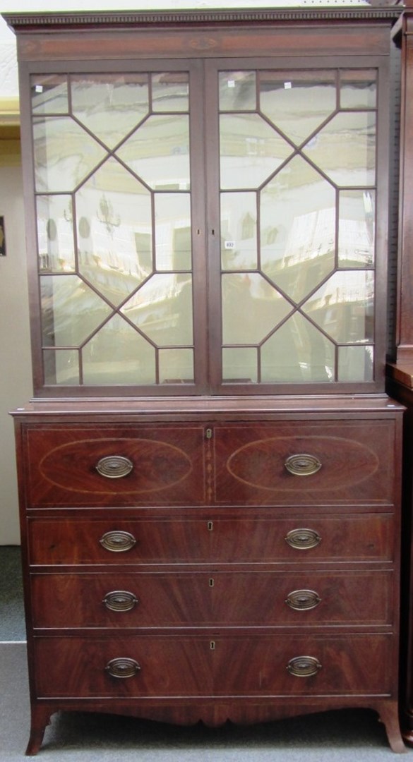 Appraisal: A George III mahogany secretaire bookcase with oval paterae and