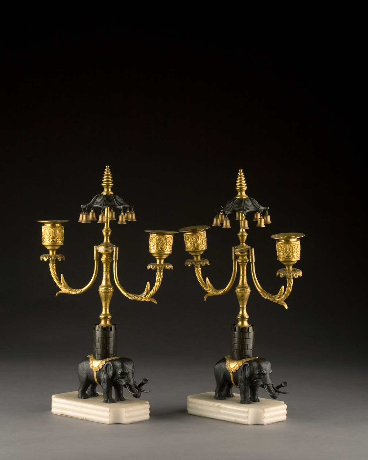 Appraisal: PAIR OF REGENCY PATINATED AND GILT-BRONZE FIGURAL TWO-LIGHT CANDLESTICKS EARLY