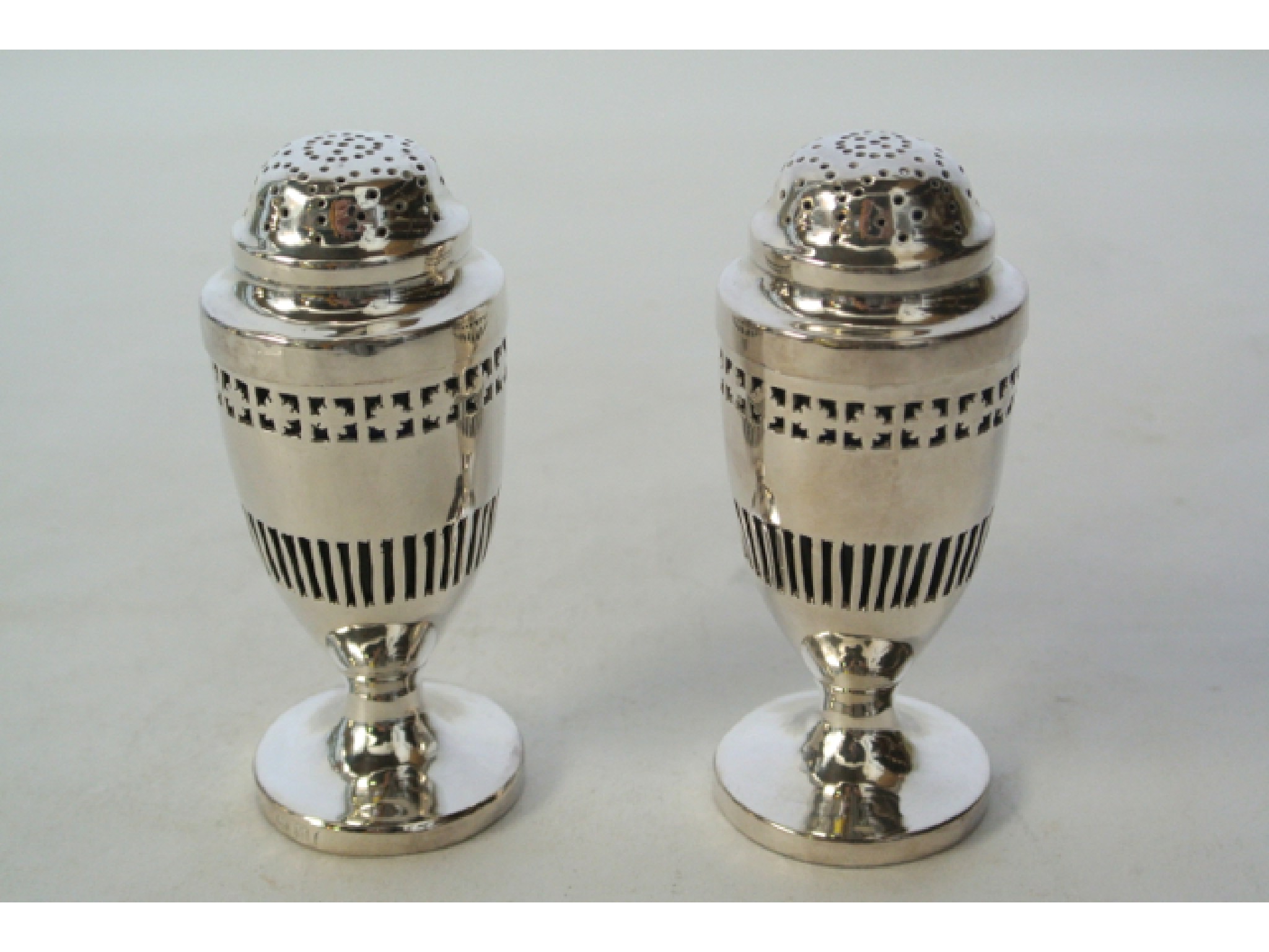 Appraisal: A pair of George III silver pepper casters maker's mark