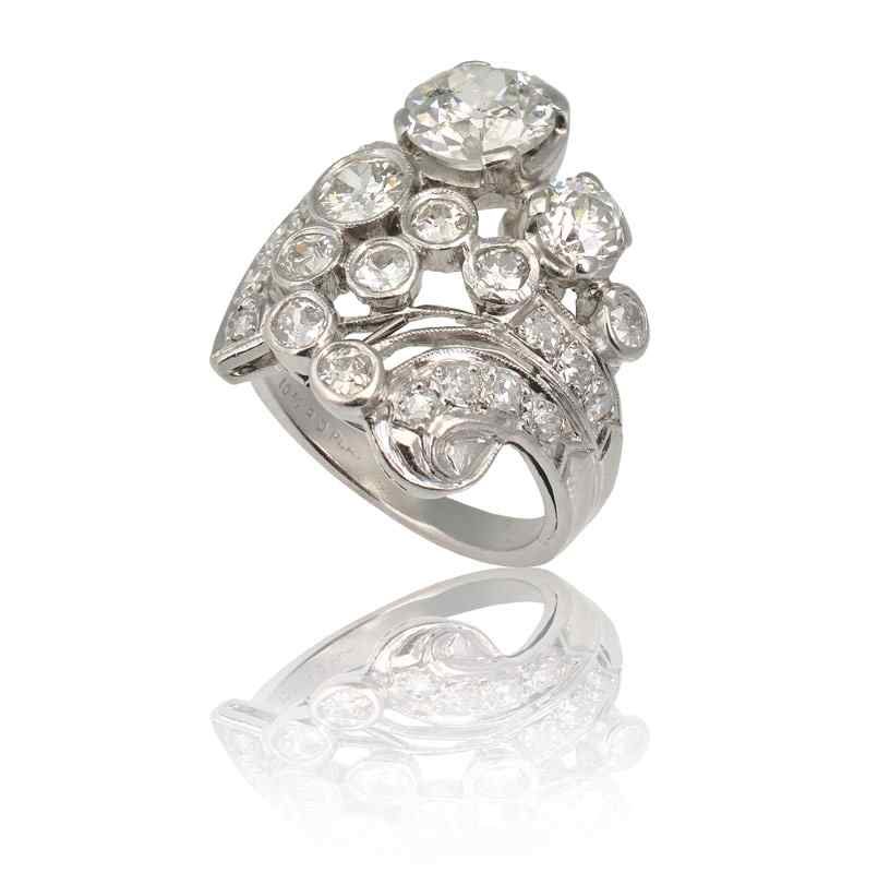 Appraisal: ART DECO PLATINUM DIAMOND COCKTAIL RING Asymmetrical design featuring an