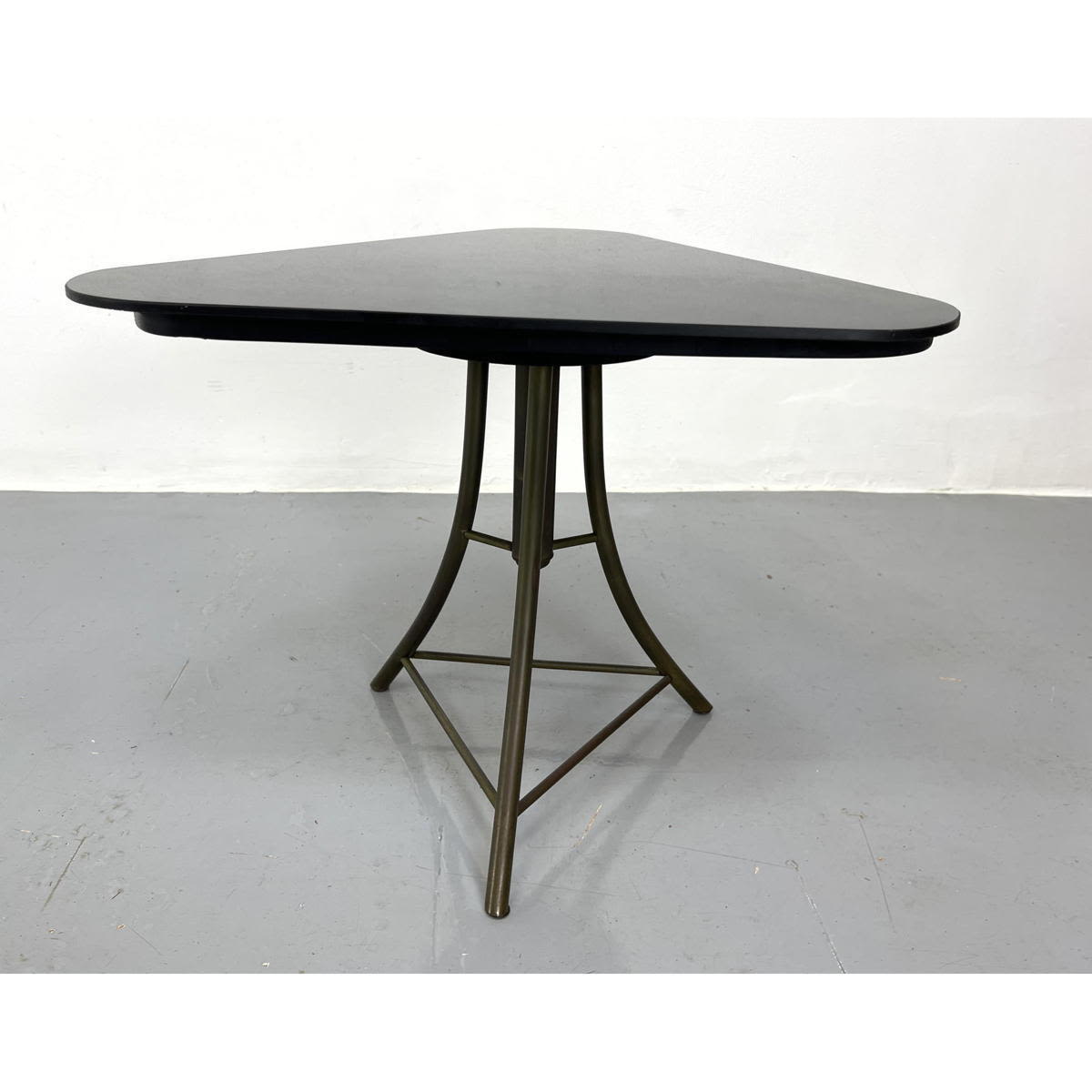 Appraisal: Black glass top triangle table with brass base Revolving Dimensions