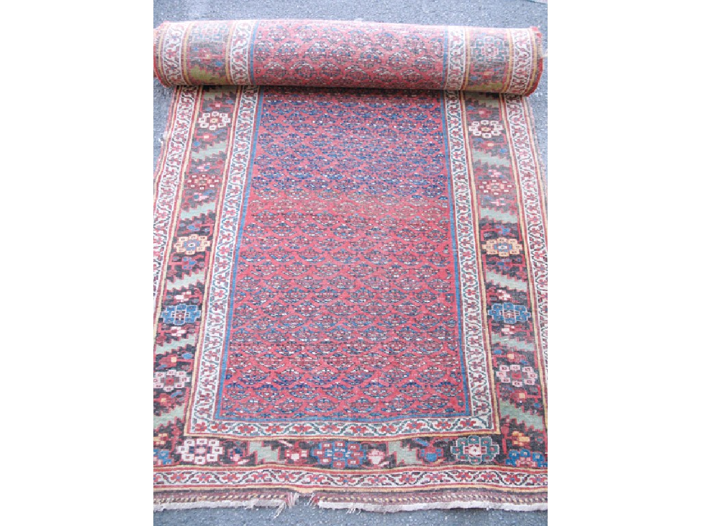 Appraisal: A NORTH WEST PERSIAN TRIBAL RUNNER the central brick red