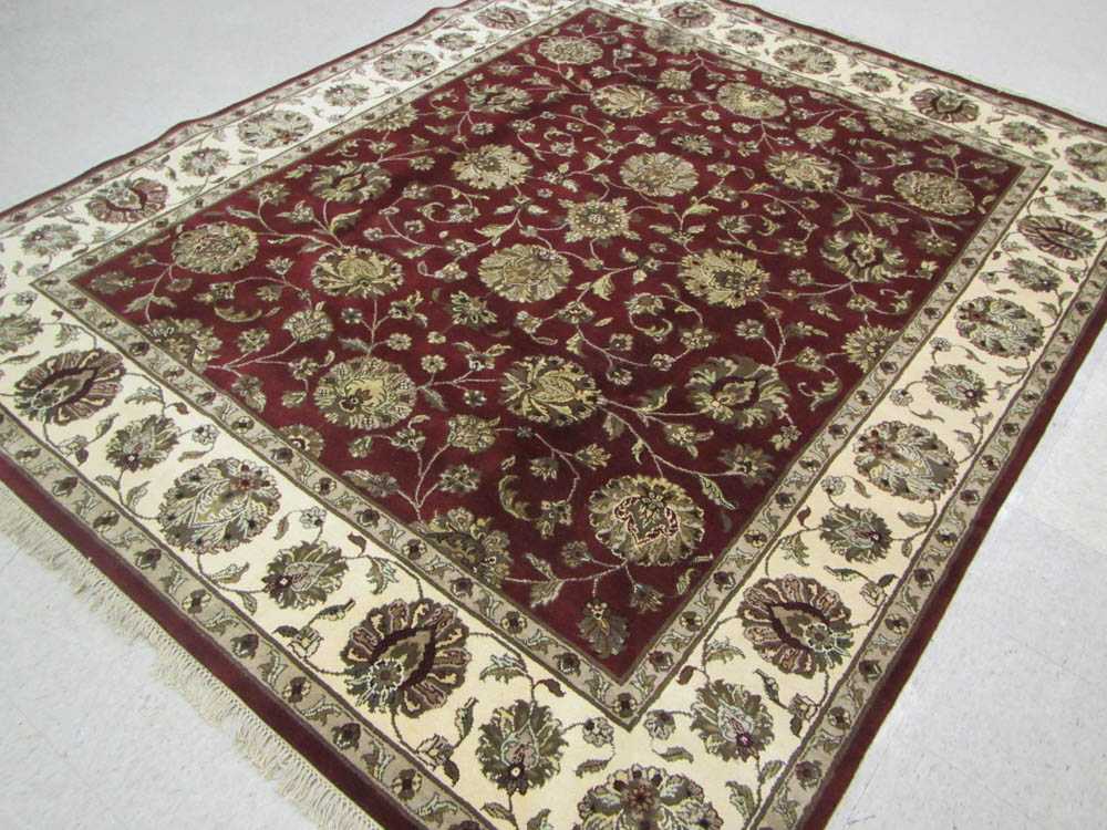 Appraisal: HAND KNOTTED ORIENTAL CARPET Indo-Persian overall floral decoration on plum