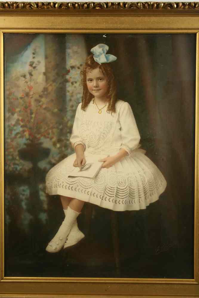 Appraisal: HANDCOLORED PHOTOGRAPH - 'Little May' seated in a white linen