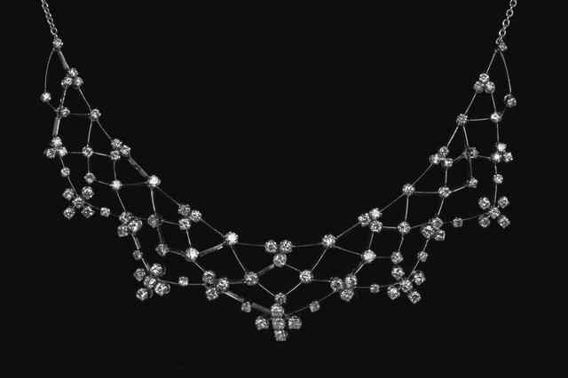 Appraisal: A diamond set white gold open trellis work necklace claw