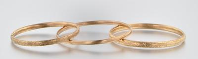 Appraisal: Three Gold Bangles One is k yellow gold hinged engraved