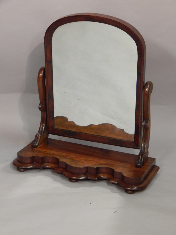 Appraisal: A Victorian figured mahogany dressing table mirror with shaped plate