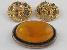 Appraisal: An oval amber brooch set in white metal tests silver