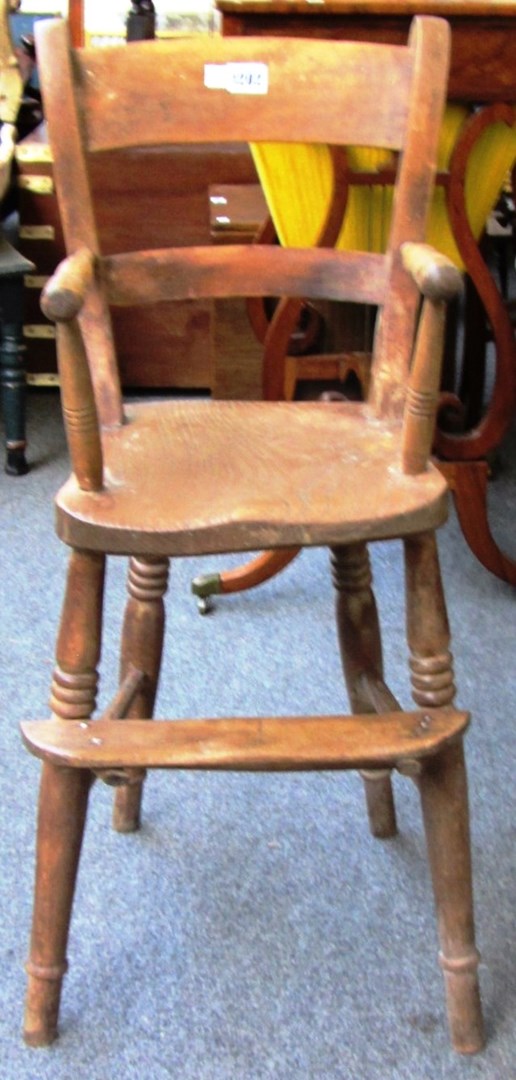 Appraisal: A Victorian beech and elm child's high chair on turned