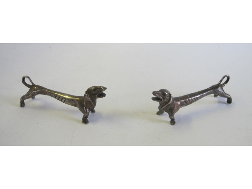 Appraisal: Pair of white metal knife rests modelled as dachshunds