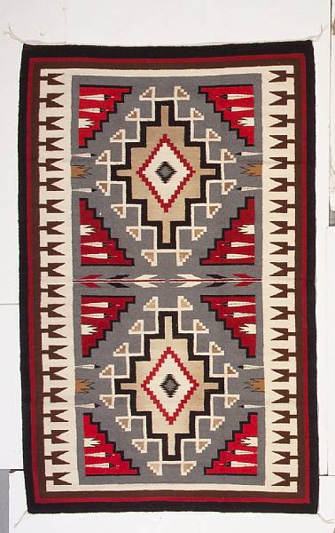 Appraisal: A Navajo pictorial rug Two central stepped diamonds separated by