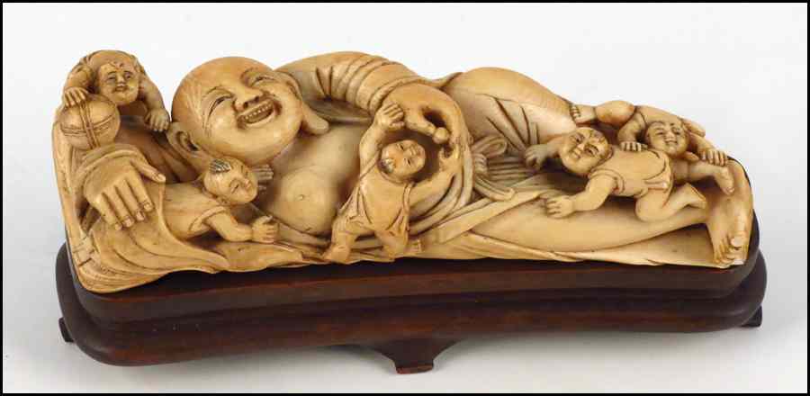 Appraisal: CHINESE CARVED IVORY FIGURE OF A RECLINING BUDDHA WITH CHILDREN