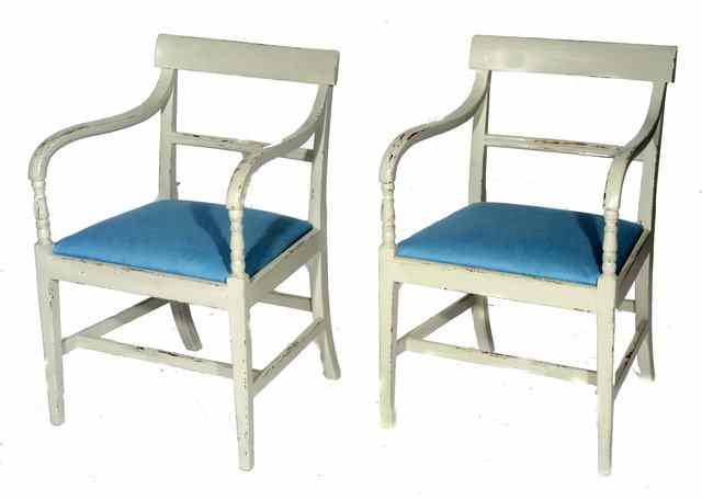 Appraisal: A PAIR OF REGENCY LATER PAINTED ARMCHAIRS with blue upholstered