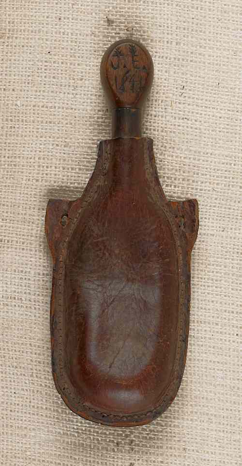 Appraisal: Leather powder flask dated having a carved human head stopper