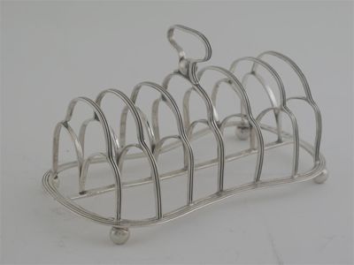 Appraisal: A George III reeded toast rack of waisted outline with