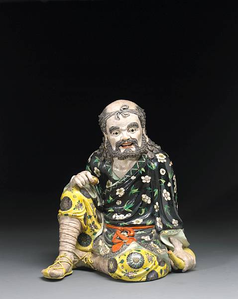 Appraisal: A famille noire enameled seated figure of Xianglong Late Qing