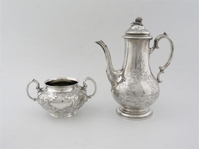 Appraisal: A Victorian three-piece tea service of bulbous form with foliate