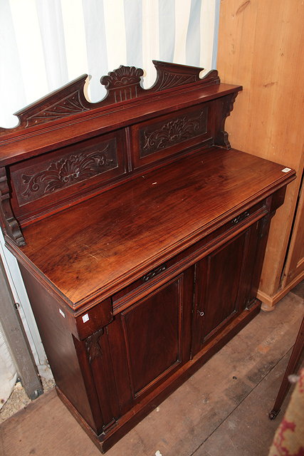 Appraisal: A VICTORIAN WALNUT CHIFFONIER the raised carved panelled back over