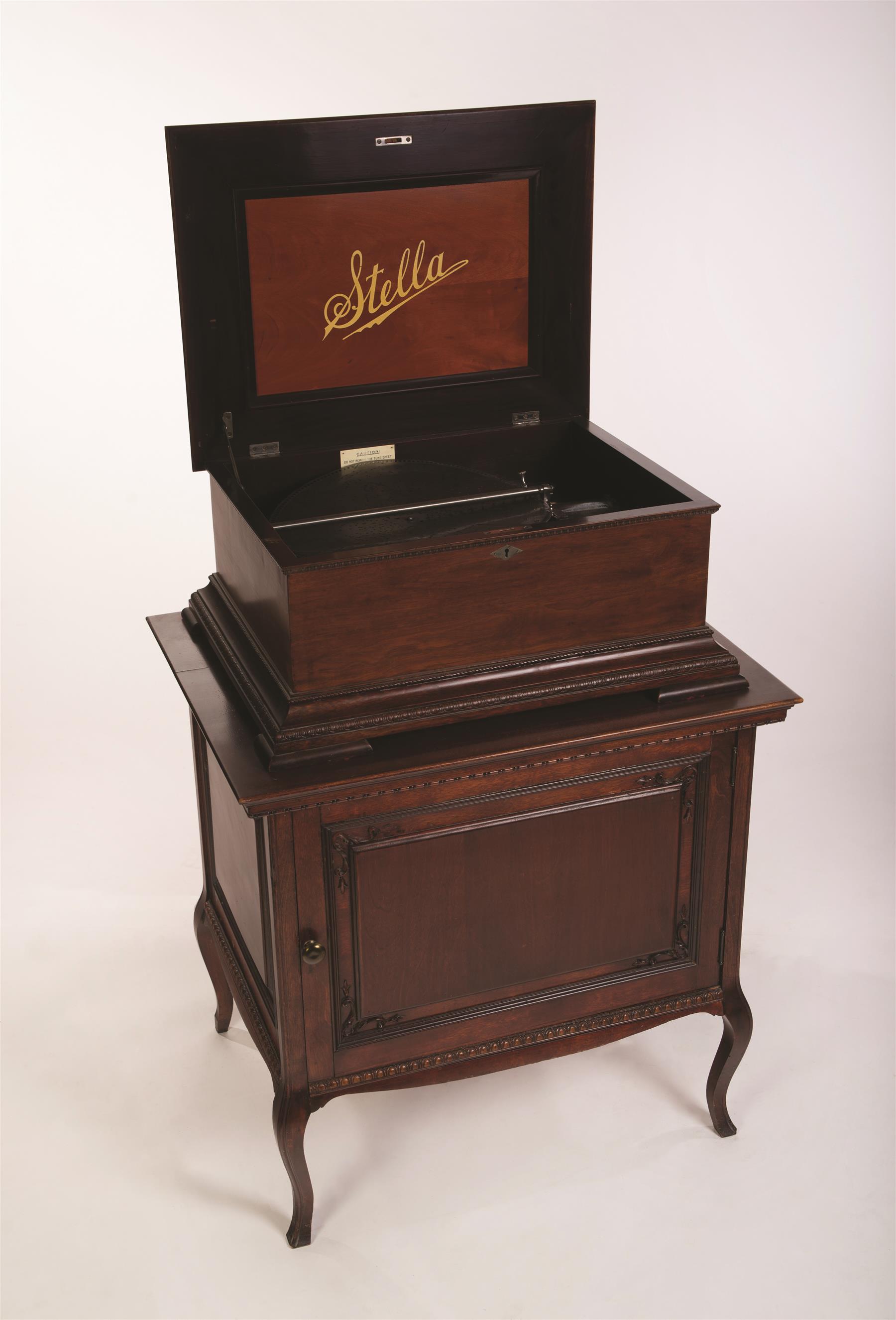 Appraisal: STELLA MUSIC BOX WITH MATCHING STORAGE CABINET AND SEVENTY-FIVE DISCS