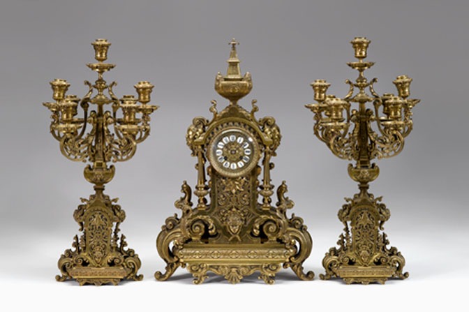 Appraisal: Continental gilt metal three-piece clock garniture probably french Comprising a