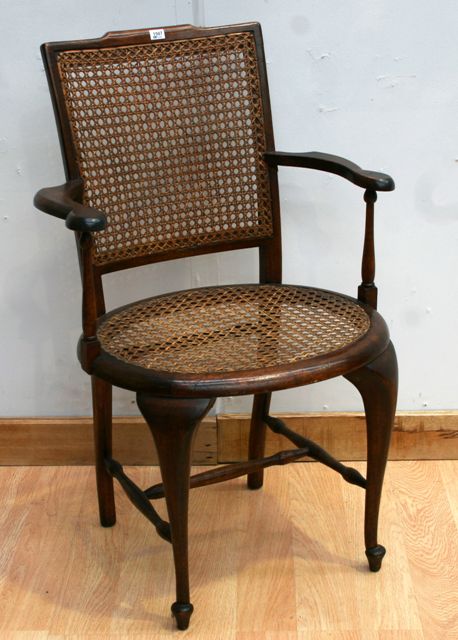 Appraisal: A walnut and caned armchair