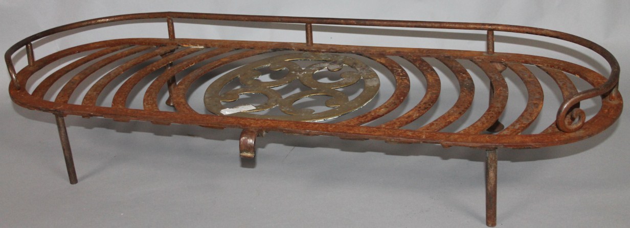 Appraisal: A late thC iron framed trivet with a brass pierced