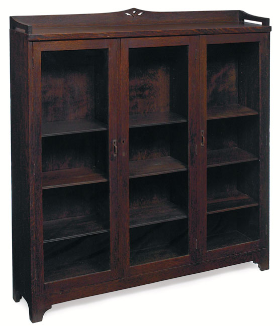 Appraisal: Arts amp Crafts bookcase three-door form with pierced design at