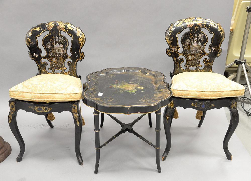 Appraisal: Three black lacquered pieces pair of chairs gilt decorated with