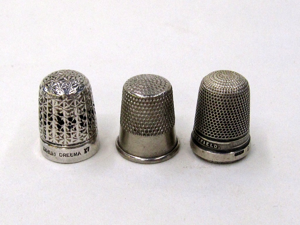 Appraisal: Lot comprising two silver thimbles and one other