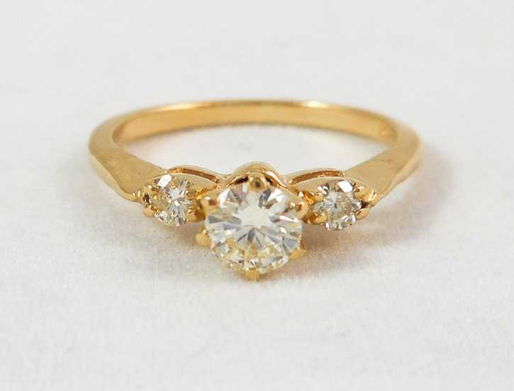 Appraisal: THREE-STONE DIAMOND AND FOURTEEN KARAT GOLD RING with two round