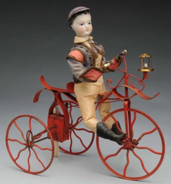 Appraisal: Mechanical Clockwork Boy Riding Bicycle Description French th Century Bisque