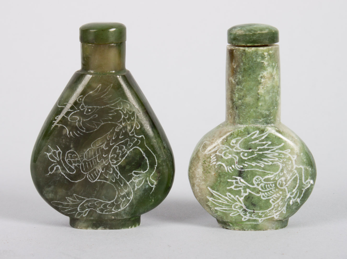 Appraisal: Two Chinese carved jade snuff bottles both with etched dragon