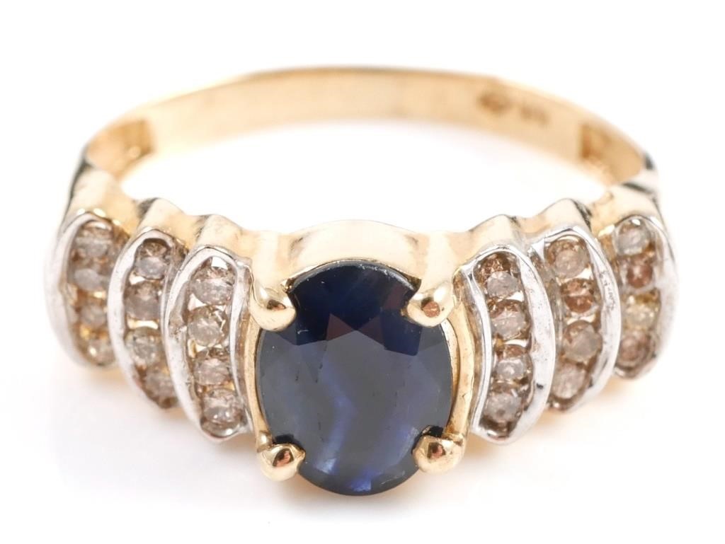 Appraisal: K yellow gold fashion ring contains one oval faceted sapphire