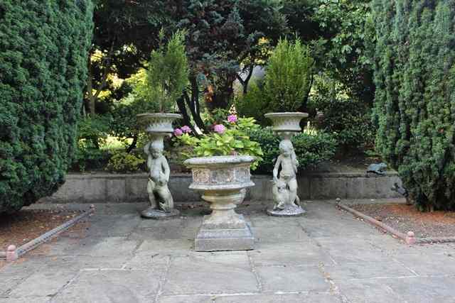 Appraisal: A PAIR OF RECONSTITUTED STONE GARDEN ORNAMENTS in the form