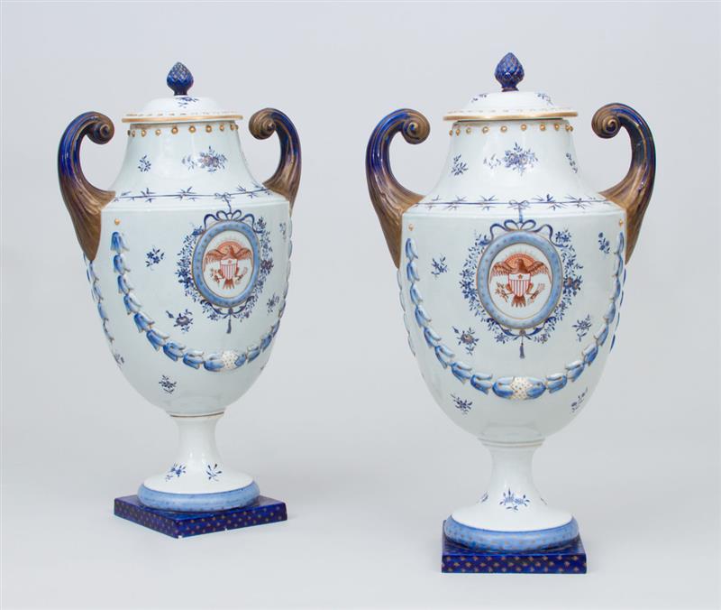 Appraisal: PAIR OF CHINESE EXPORT STYLE PORCELAIN PISTOL-HANDLED URNS AND COVERS