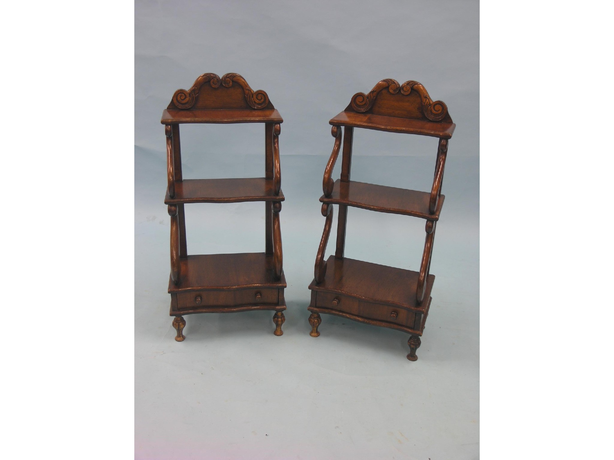 Appraisal: A pair of Victorian-style mahogany dwarf whatnots each with three