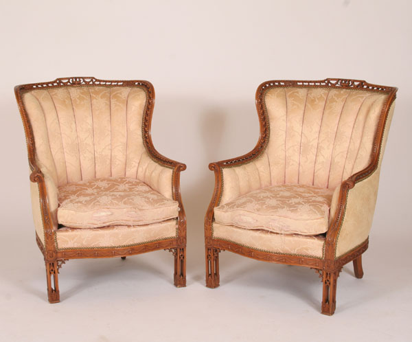 Appraisal: Pair pierce carved upholstered wing arm chairs ornate and intricate