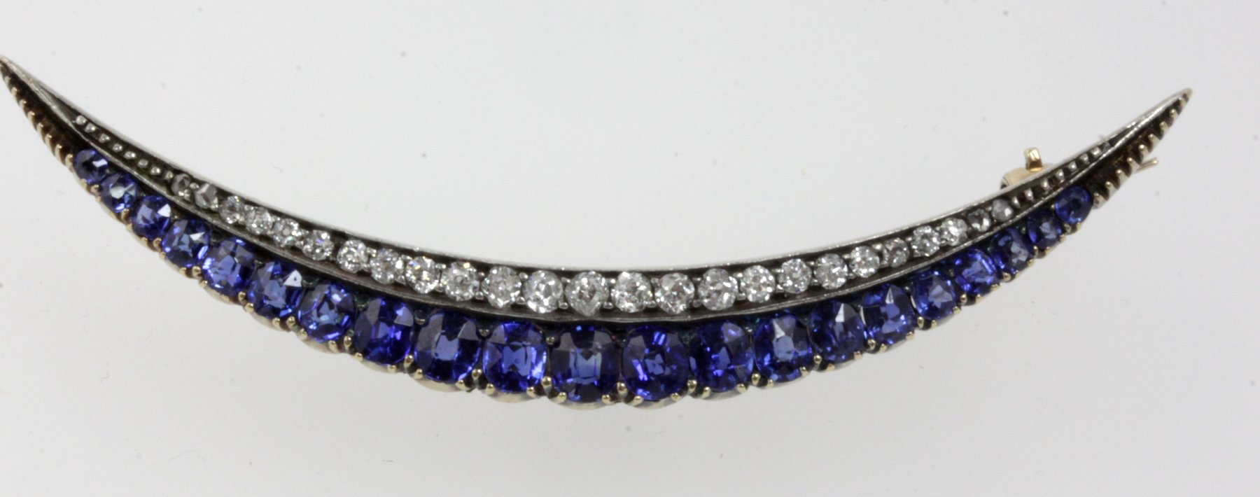 Appraisal: A sapphire and diamond crescent brooch the two rows of