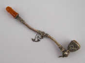 Appraisal: A silver filigree opium pipe with amber mouthpiece