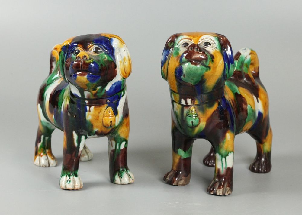 Appraisal: Chinese porcelain dogs possibly th c egg-and-spinach glazed porcelain dogs