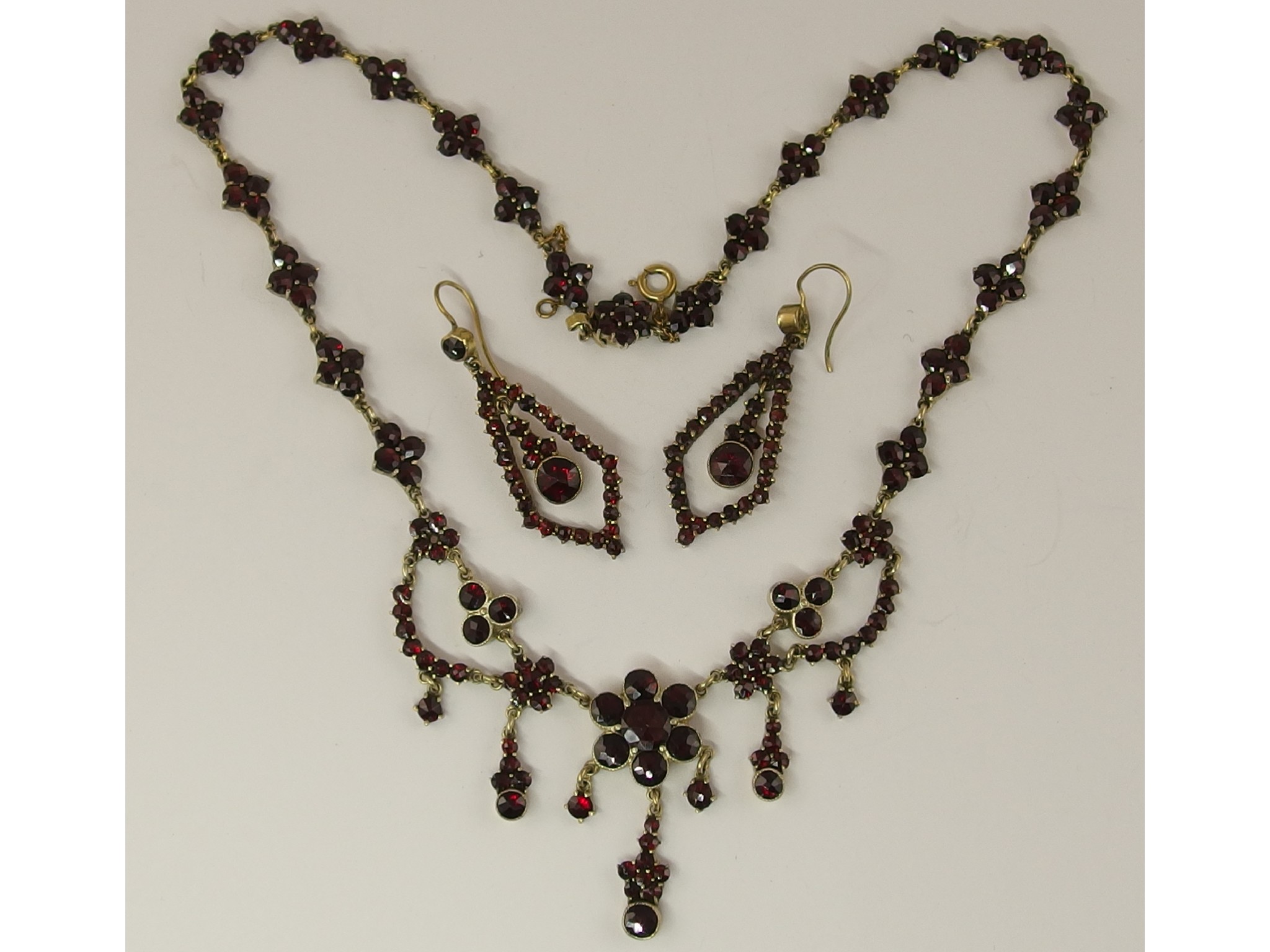 Appraisal: A gilded white metal garnet set necklace and earrings