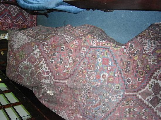 Appraisal: A CAUCASIAN RUG with three panels of geometric designs x