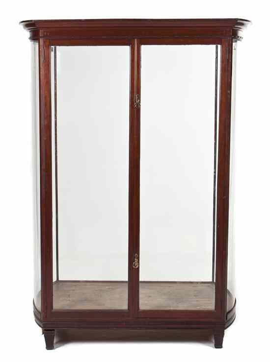 Appraisal: An English Mahogany Vitrine with an over hanging cornice above