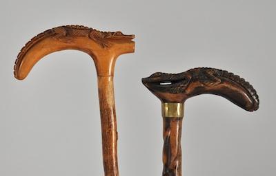 Appraisal: Two Wood Walking Sticks with Alligator Handles The first made