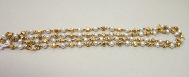 Appraisal: A gold and cultured pearl necklace in a faceted bead